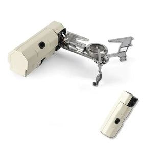 Beige and silver portable camping stove with foldable legs and a detachable fuel canister.