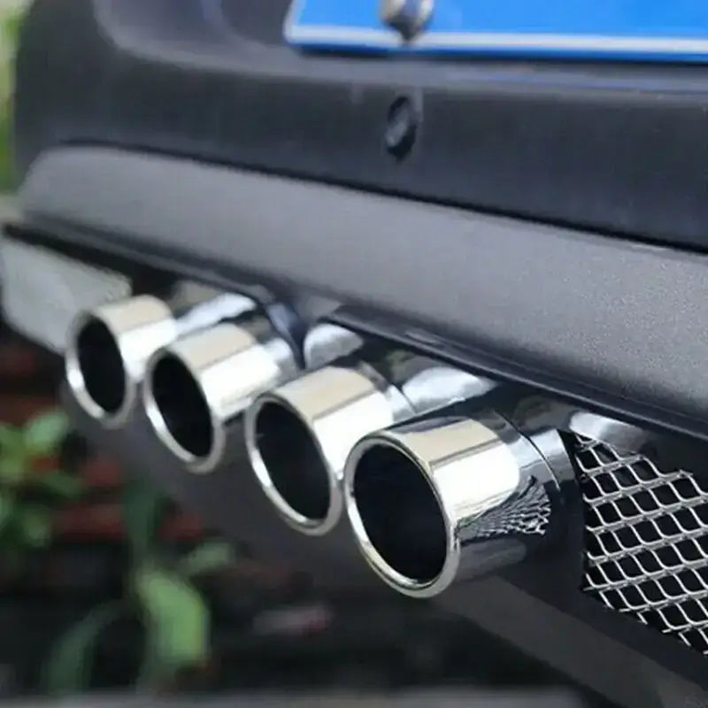 Shiny chrome exhaust tips with a sleek, cylindrical design.