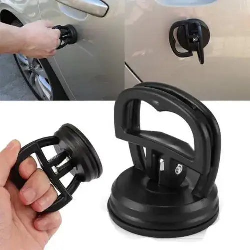 Black plastic suction cup car door handle puller with a sturdy d-shaped grip and reinforced base.