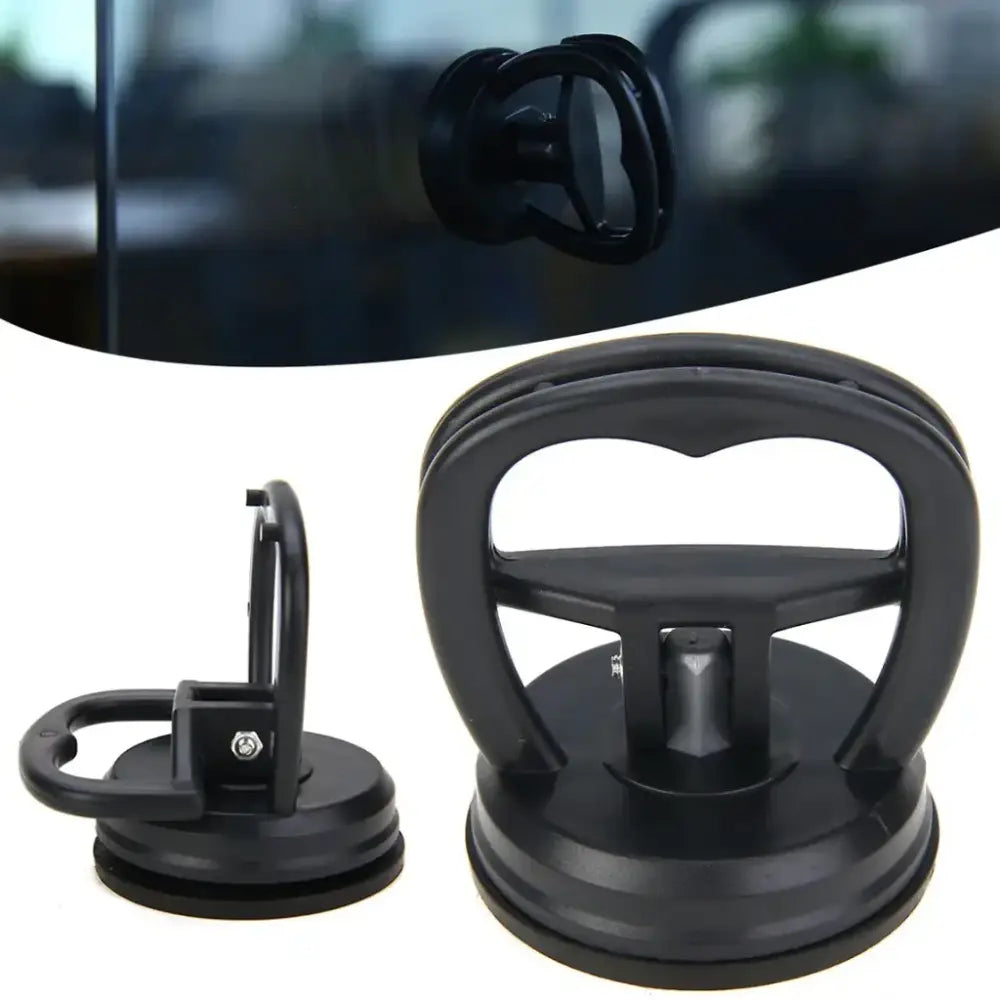Black plastic suction cup window removal tool with a sturdy handle and adjustable grip.