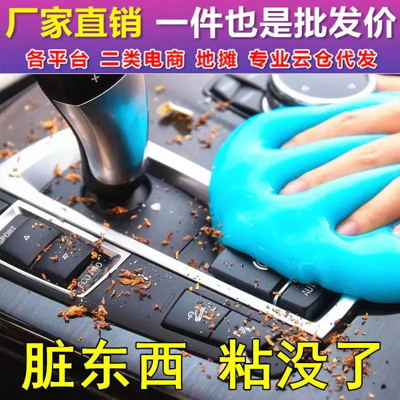 Bright blue, flexible slime being used to clean debris from a car’s center console.