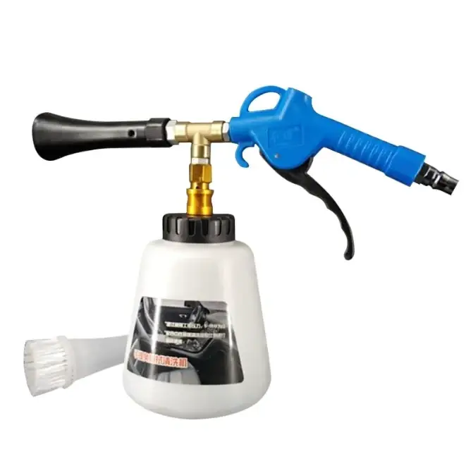 Blue and black air blow gun with a white plastic tank, gold-colored metal fittings, and an attached clear brush attachment.
