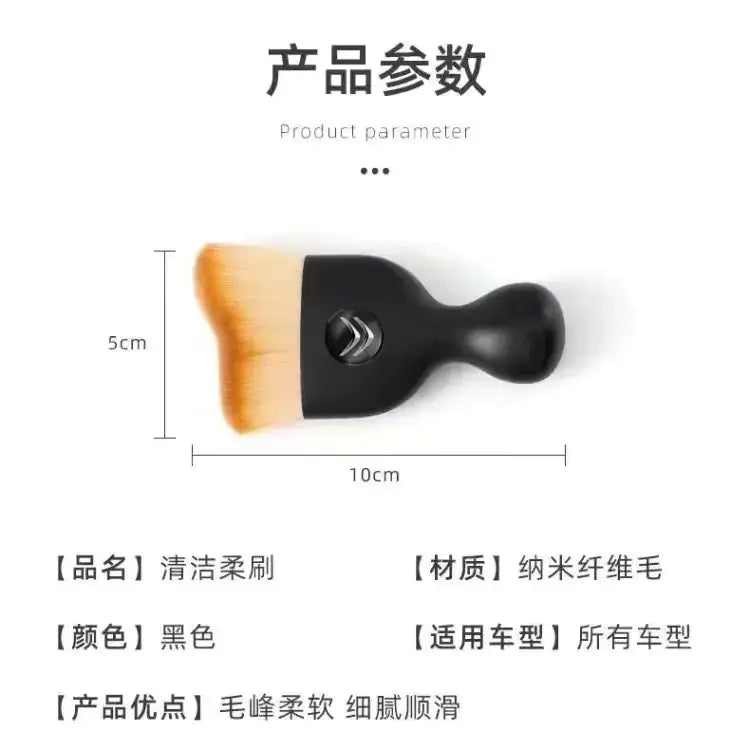Black cleaning brush with soft, orange-tipped nano-fiber bristles.