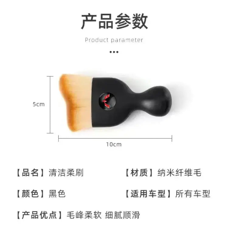 Black cleaning brush with soft, orange-tipped nano-fiber bristles.