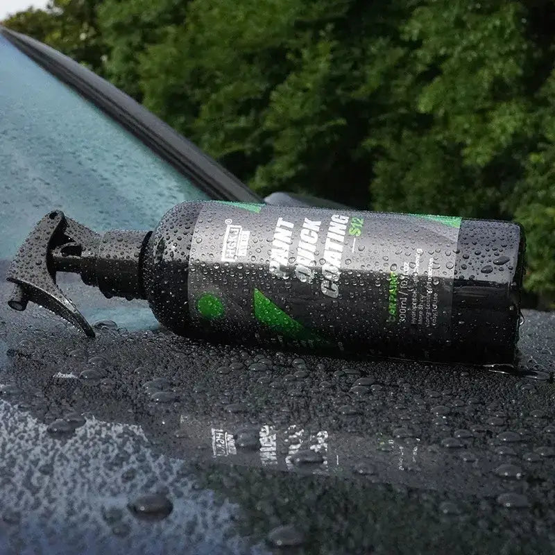 Black spray bottle with green and white labeling, featuring ’paint quick coating’ text.