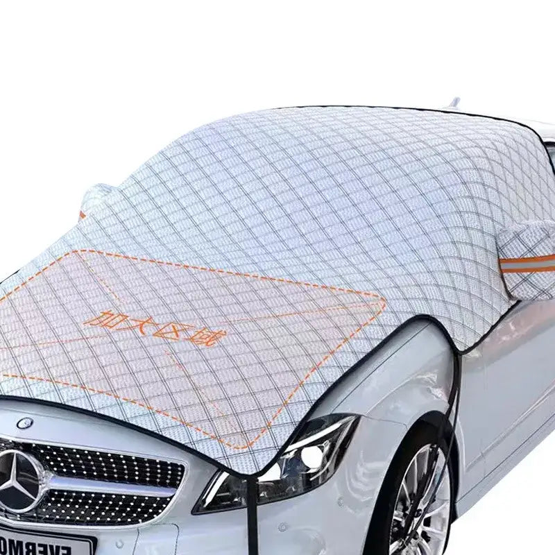 White quilted car windshield cover with black grid pattern and orange stitching.