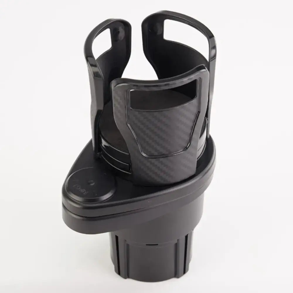 Black plastic car cup holder with a carbon fiber textured insert and two curved handles.