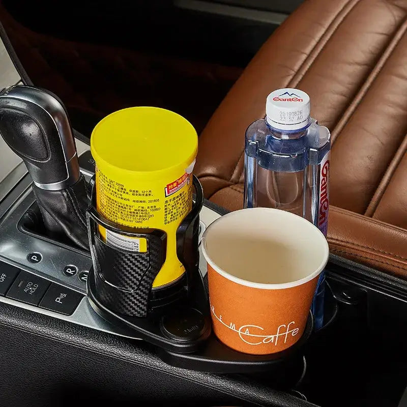 Black carbon fiber textured car cup holder with integrated slots for a water bottle and paper coffee cup.