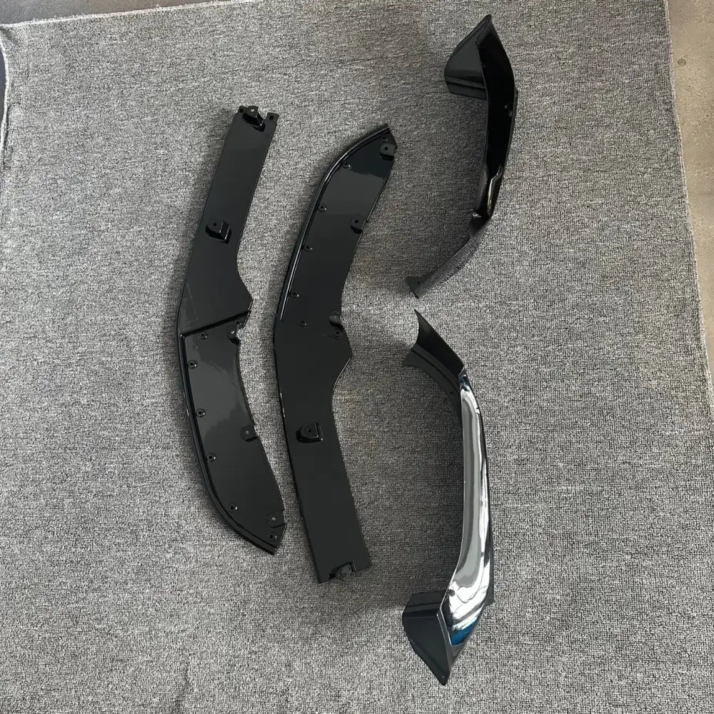 Black and chrome automotive side skirt splitters, featuring a glossy finish with integrated mounting hardware.