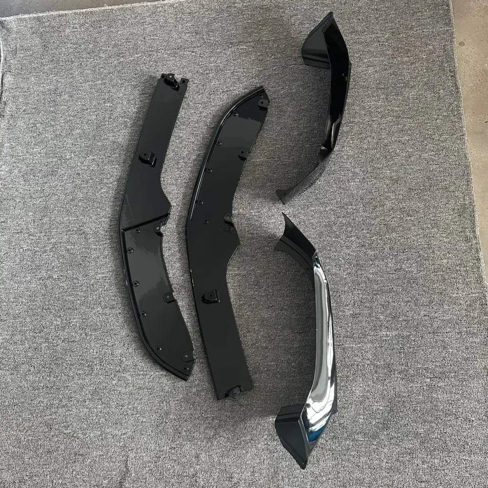 Set of three black and chrome automotive front fender flares with glossy finish.