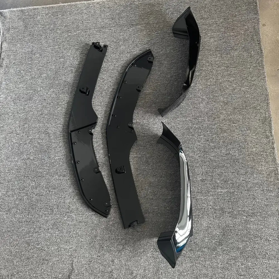 Set of three black and chrome automotive front fender flares with glossy finish.