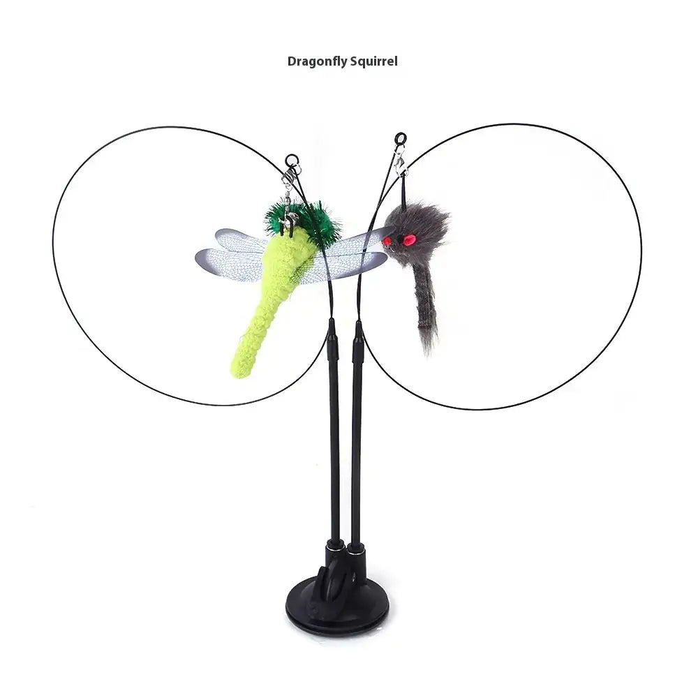 A playful cat toy featuring a bright green dragonfly with translucent wings and a fuzzy gray squirrel with red eyes, both suspended on black wires from an adjustable stand.