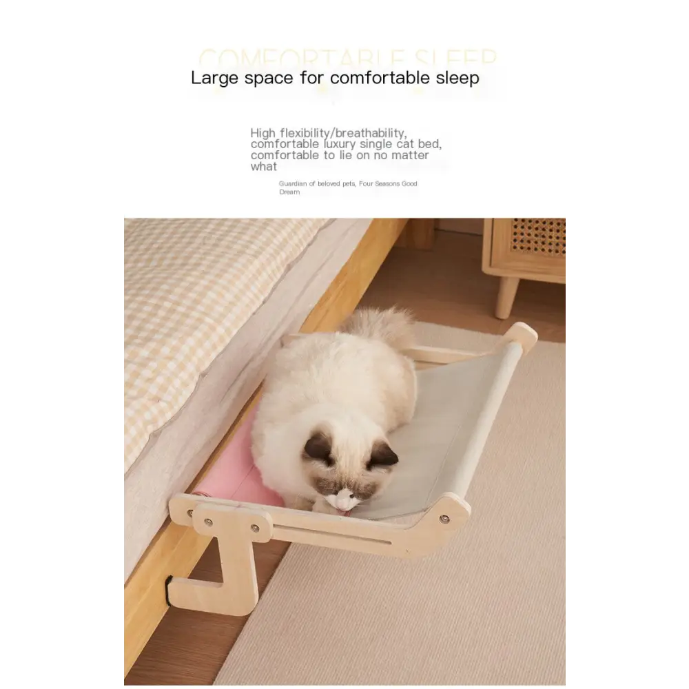 A beige and pink fabric cat bed with a wooden frame, designed for comfortable sleeping.