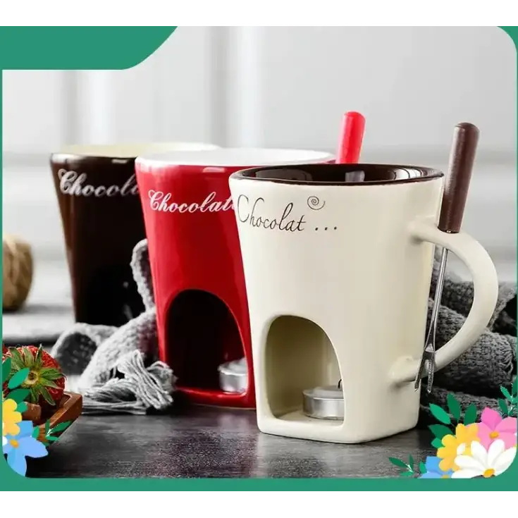 Cream-colored ceramic chocolate fondue mug with a built-in heating compartment and a wooden-handled spoon inserted into its side.