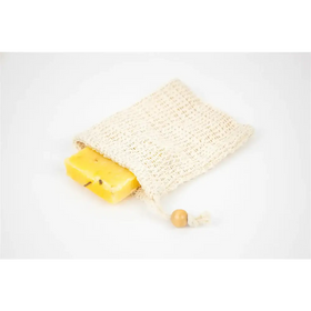A beige, knitted mesh soap bag with a wooden toggle closure holds a rectangular yellow bar of soap.