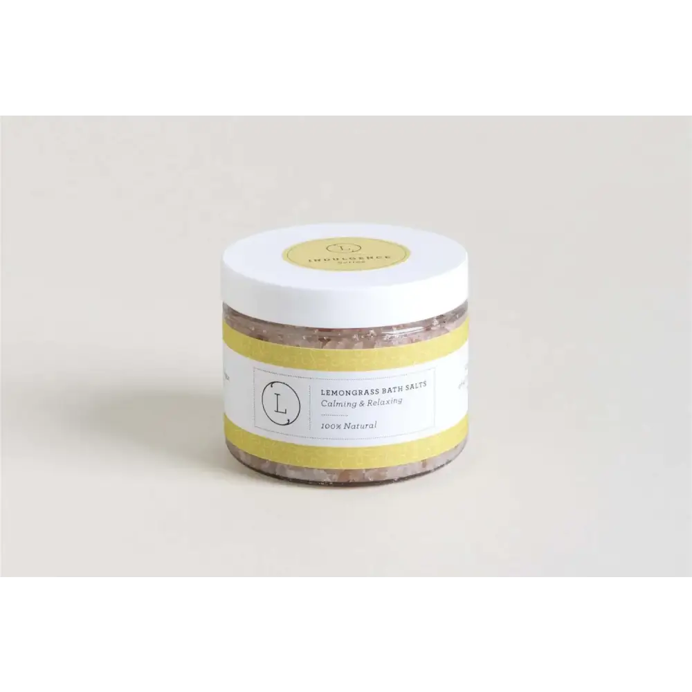 A white cylindrical jar with a yellow label and lid, containing lemongrass bath salts.