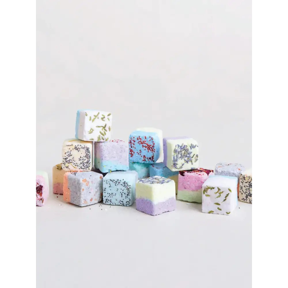 Colorful, cube-shaped bath bombs with lavender and speckled designs.