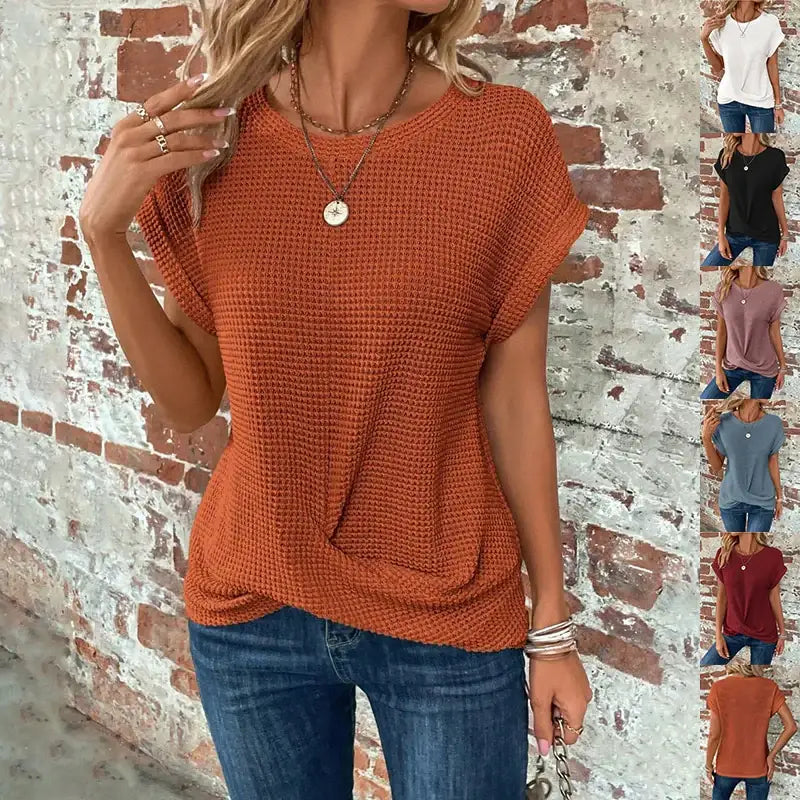 Rust-colored waffle-knit short-sleeved top with a round neckline and front twist detail