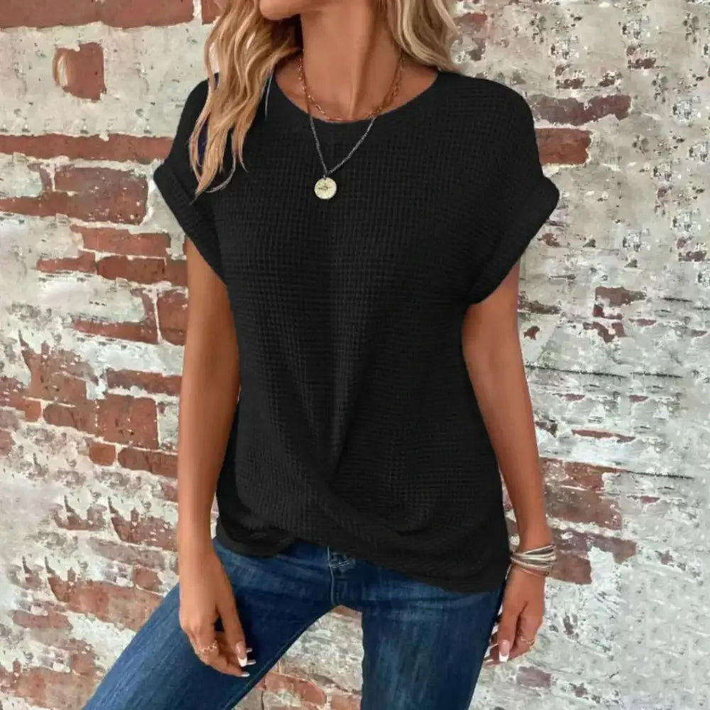 Black waffle-knit short-sleeved top with a relaxed fit and rounded neckline