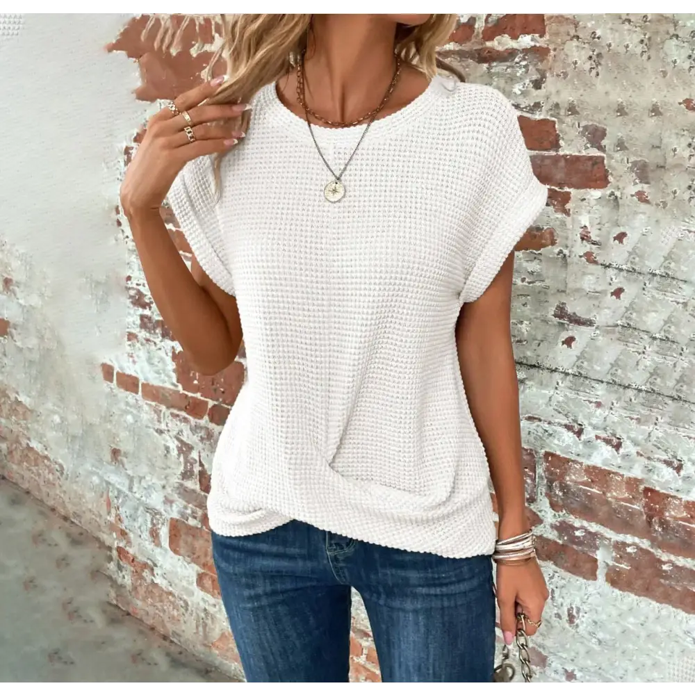 White waffle-knit short-sleeved top with a round neckline and front knot detail