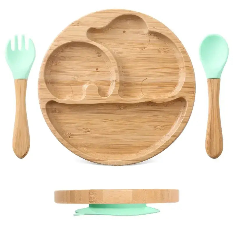 Bamboo elephant-shaped children’s plate with mint green silicone utensils and suction base.