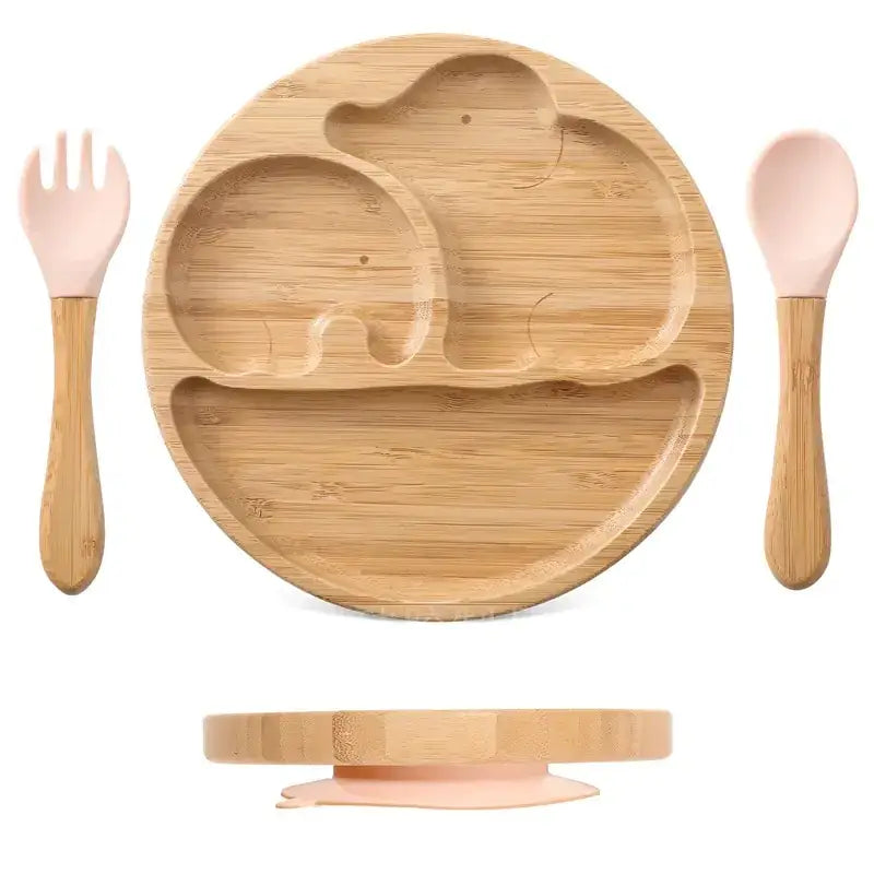 Bamboo elephant-shaped children’s plate with pink silicone utensils and suction base.