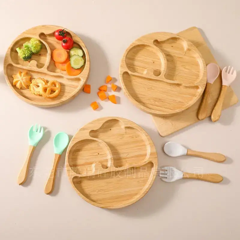 Light brown bamboo baby plates with rounded edges and divided sections for different food types.
