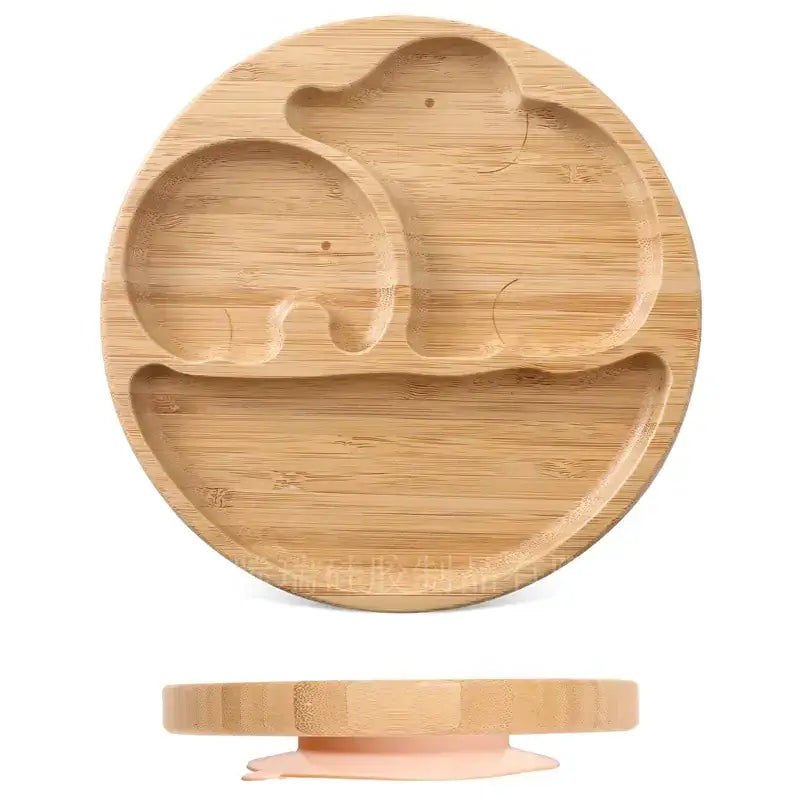 Light brown bamboo children’s plate featuring carved elephant shapes and a suction cup base.
