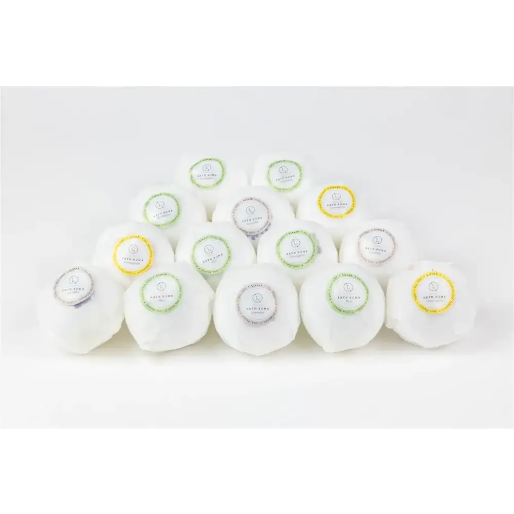 White bath bombs with colorful circular labels in green, yellow, and silver.
