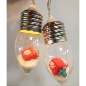 Clear glass light bulb ornaments with metallic screw bases, each containing a red gift box figurine and white glittery sand.