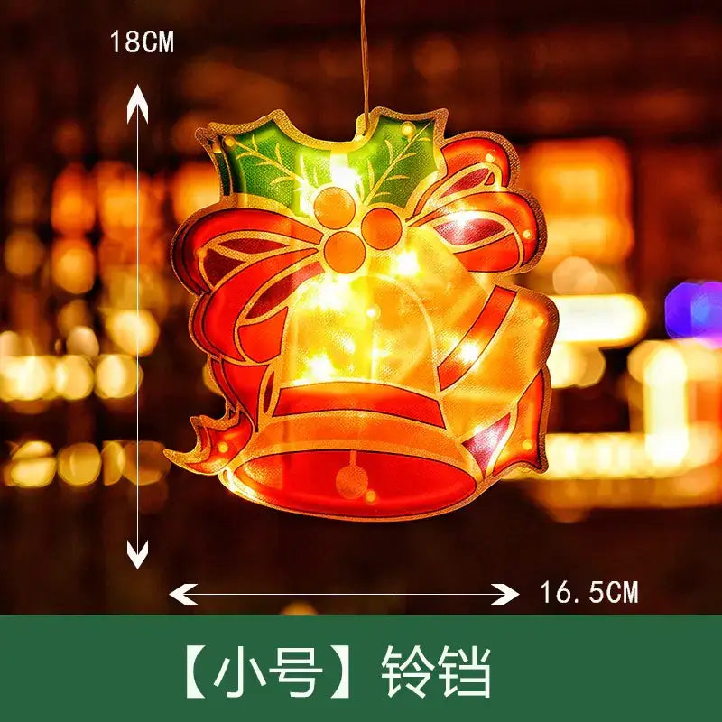 A festive, illuminated christmas bell ornament with a red bow and green holly design.