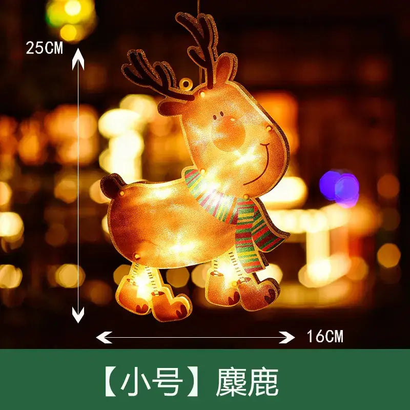 A glowing, 25cm-tall decorative reindeer light with a warm golden glow and striped green-and-red scarf.