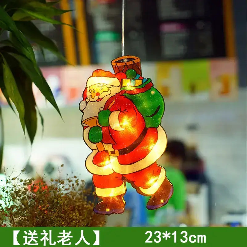 A glowing red and green santa claus hanging ornament with a festive design.