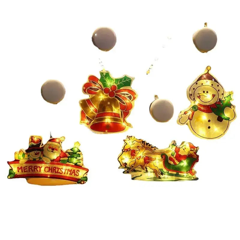 Gold and red illuminated christmas-themed decorative ornaments featuring a snowman, sleigh with reindeer, bells, holly, and santa claus.