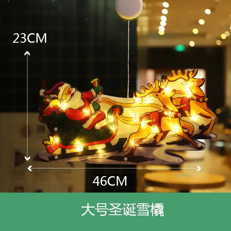 A festive, illuminated christmas sleigh decoration featuring santa claus and reindeer in vibrant reds, greens, and gold tones.