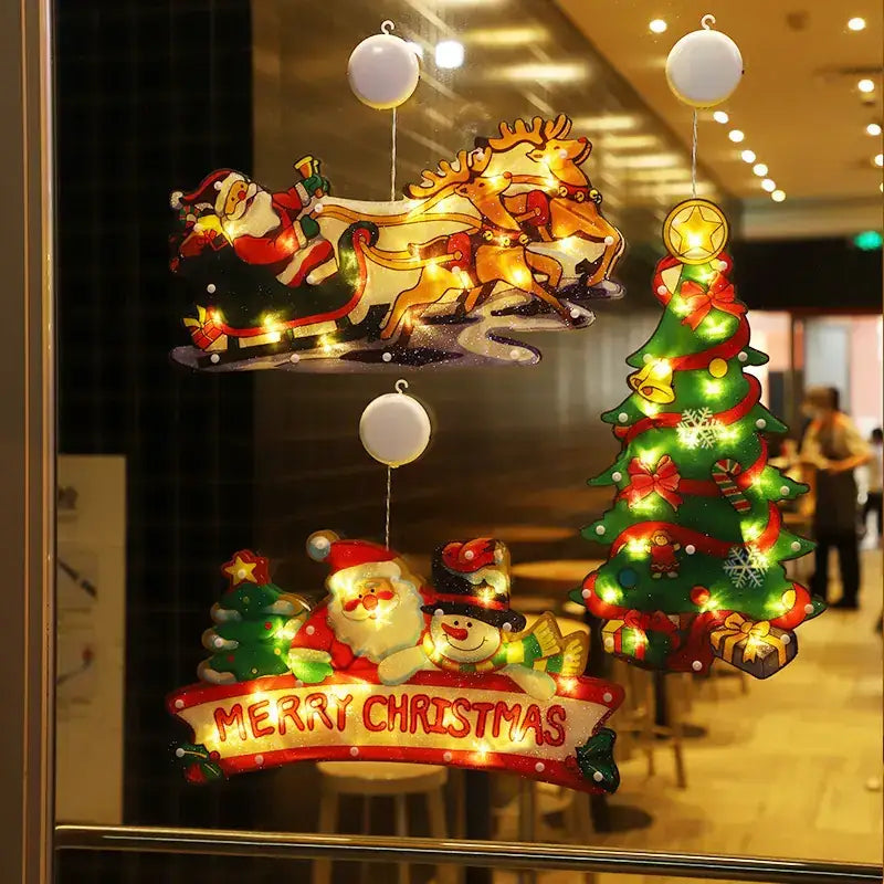 Christmas-themed illuminated window decals featuring santa, reindeer, a tree, and a snowman with ’merry christmas’ text.