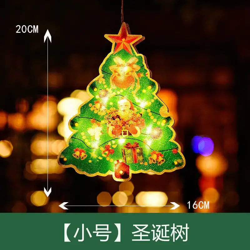 A glowing green christmas tree ornament with a red star on top, featuring festive illustrations of santa claus and gifts illuminated by internal lights.