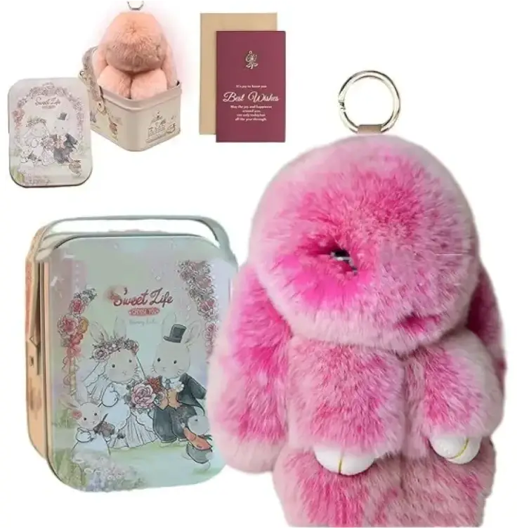 Pink fluffy bunny keychain with white paw pads and a metallic ring.