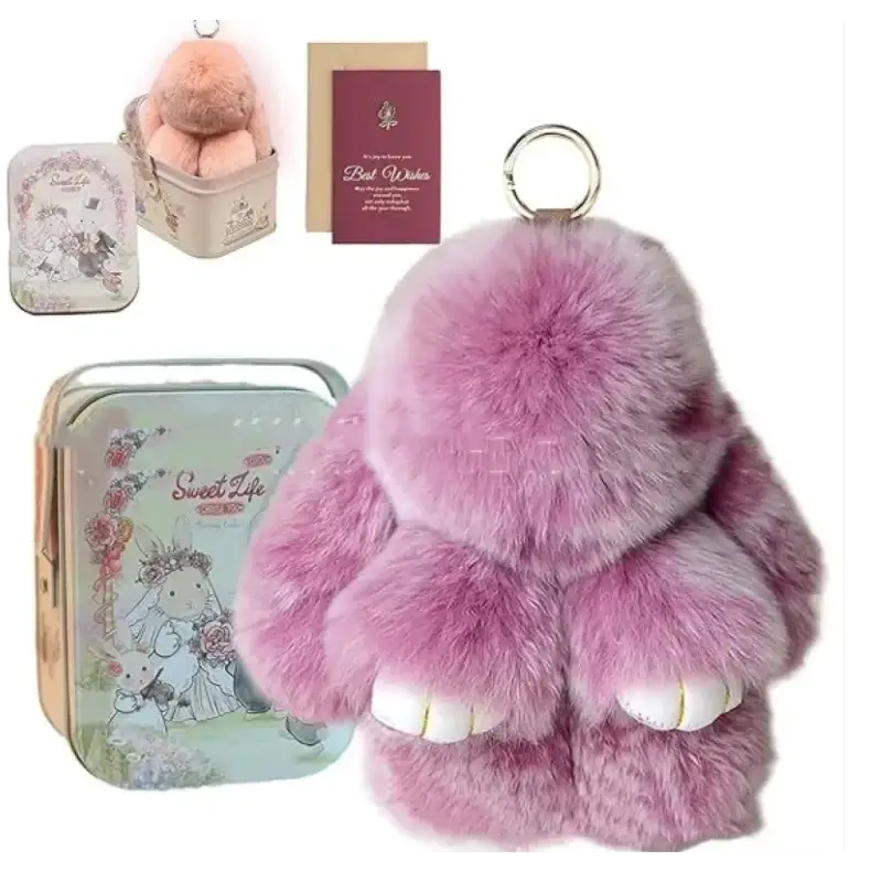Pink fluffy bunny keychain with white paw pads and a silver ring.