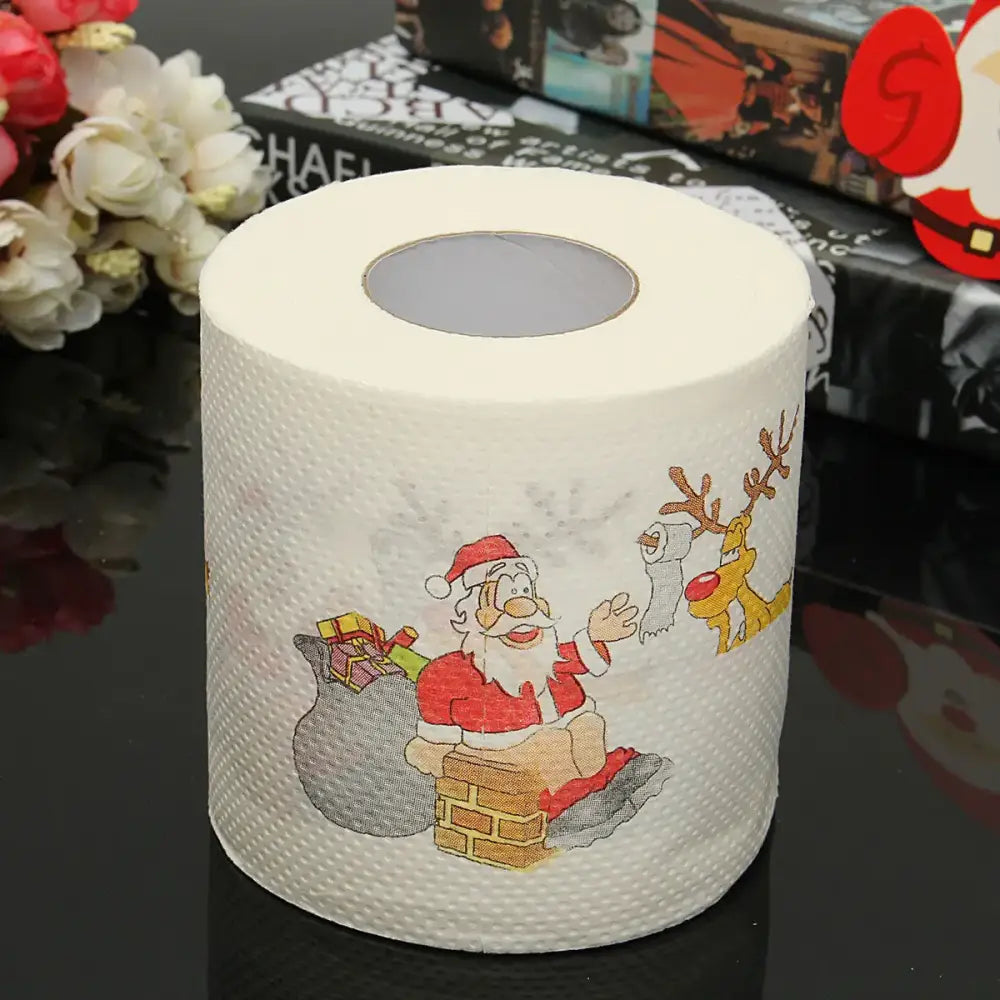 A roll of white christmas-themed toilet paper featuring a cartoon santa claus with his sack and reindeer design.