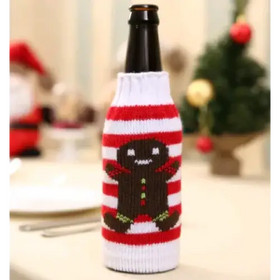 Red and white striped knitted beer bottle sleeve featuring a brown gingerbread man design.