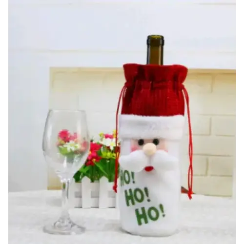 Red and white santa claus-themed wine bottle cover with a drawstring top, embroidered ’ho! Ho! Ho!’ text on the front.