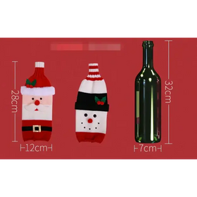 Red and white knitted wine bottle cover designed to resemble santa claus with a red hat, white beard, black belt, and green holly accents.