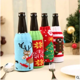 Christmas-themed knitted bottle cozies in festive colors and patterns.