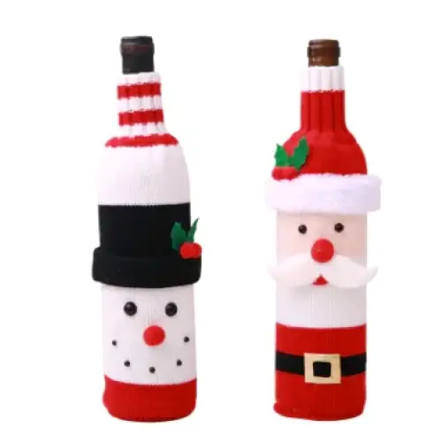 Two knitted wine bottle covers, one shaped like a snowman with red and white stripes and black hat, the other resembling santa claus in red knitwear.