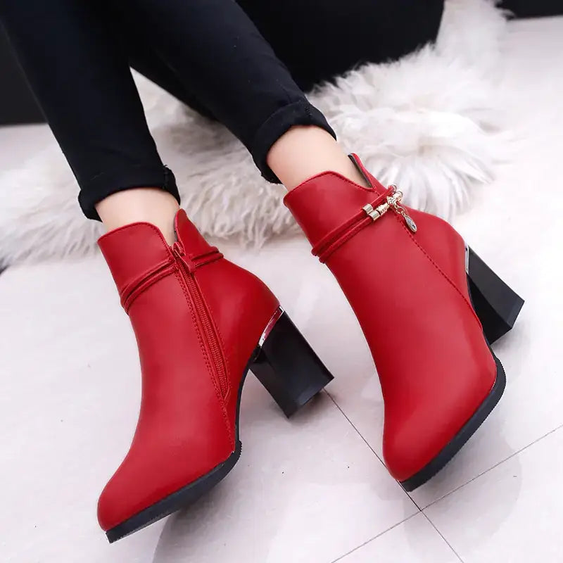 Red leather ankle boots with a black block heel and gold-tone zipper pull.