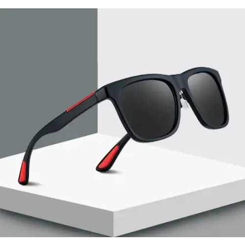 Black rectangular sunglasses with red accents on the temples and tips, featuring dark gray lenses.