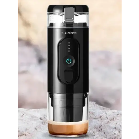 Black and transparent t-colors portable coffee maker with a green power button, stainless steel base, and brewed espresso visible at the bottom.