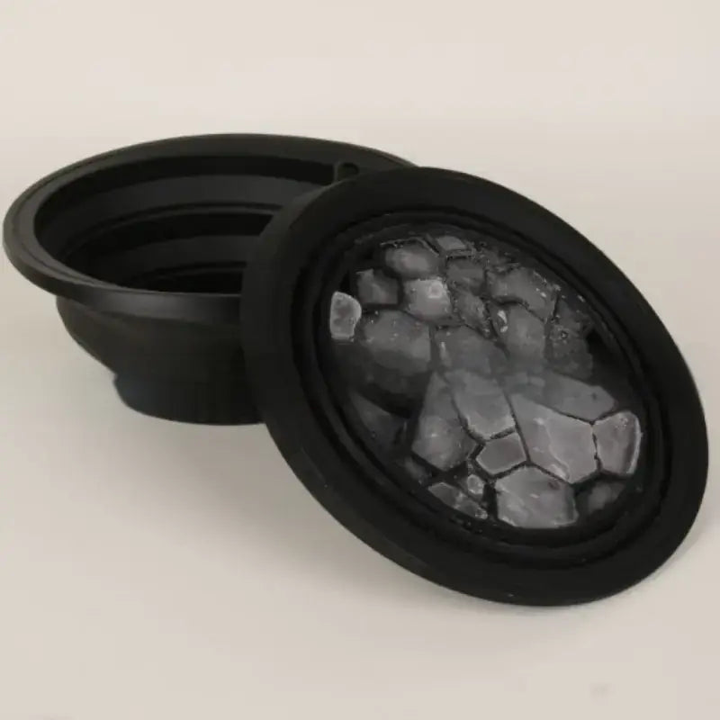 Black collapsible bowl with a textured, cracked glass-like insert