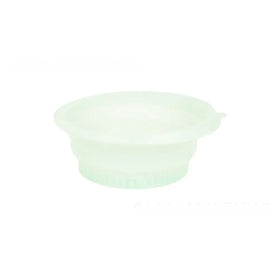 A translucent light green silicone collapsible bowl with a ribbed base and smooth rim.